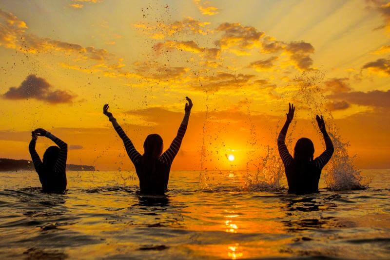 Women surfing in Bali at Ocean Soul Retreat, Sunset surf classes